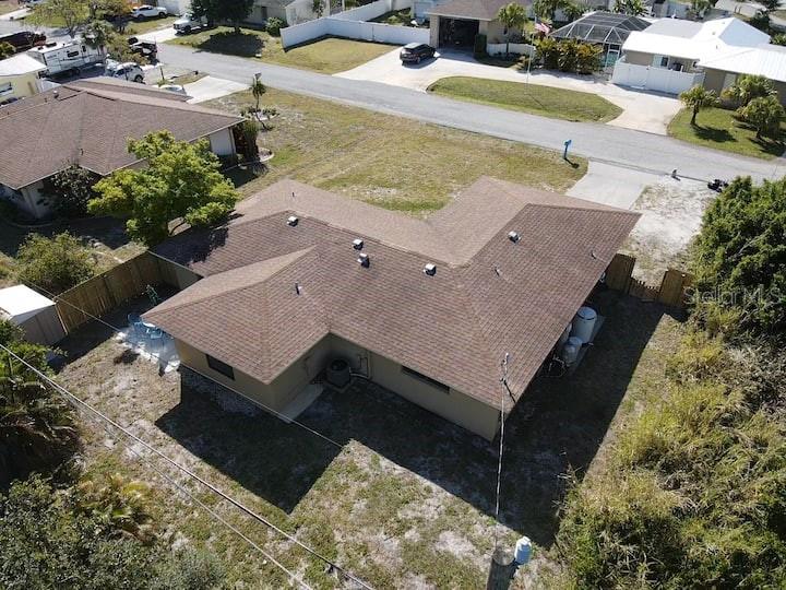 An aerial view shows a tan house with a brown shingled roof and surrounding yard — 1580 SOUTHLAND ROAD, VENICE, FL