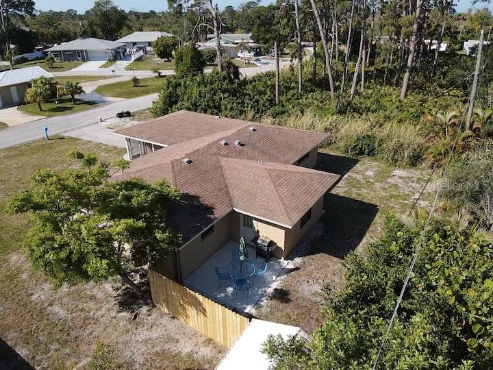 An aerial view shows a house with a brown roof and a small patio area — 1580 SOUTHLAND ROAD, VENICE, FL