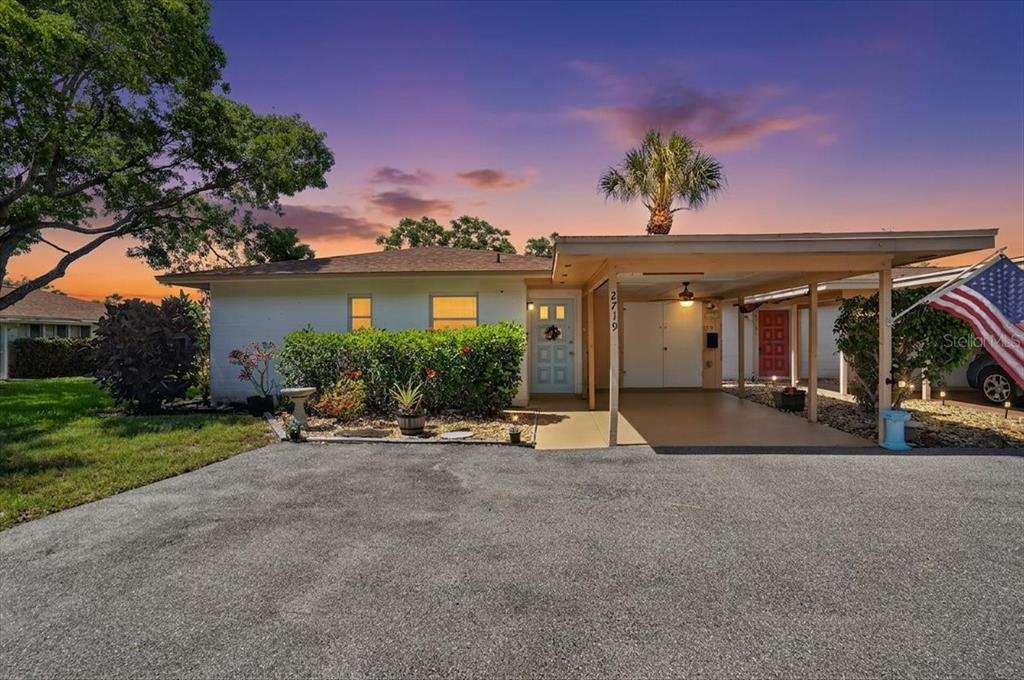 A single-story house with a carport, a paved driveway, and a landscaped front yard — 2719 51ST AVENUE W, BRADENTON, FL