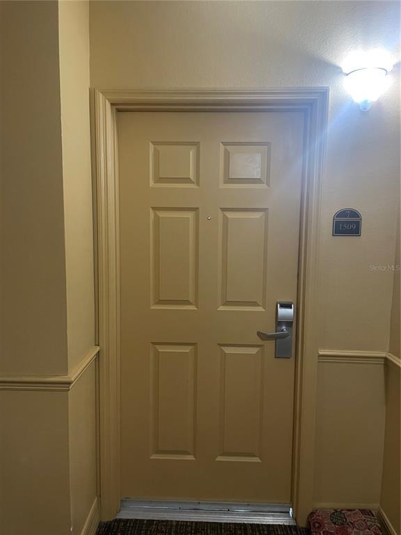 A beige interior door with a silver handle and the number 1509 on the wall — 8112 POINCIANA BOULEVARD UNIT 1509, ORLANDO, FL