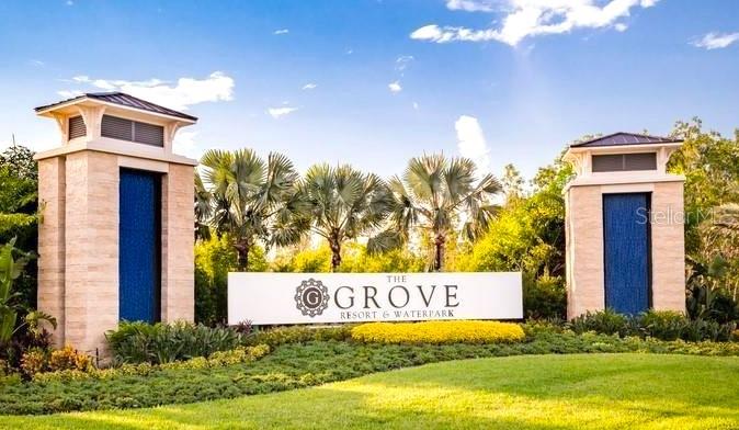 The entrance sign for The Grove Resort & Waterpark features two stone pillars and landscaping — 14501 GROVE RESORT AVENUE UNIT 2214, WINTER GARDEN, FL