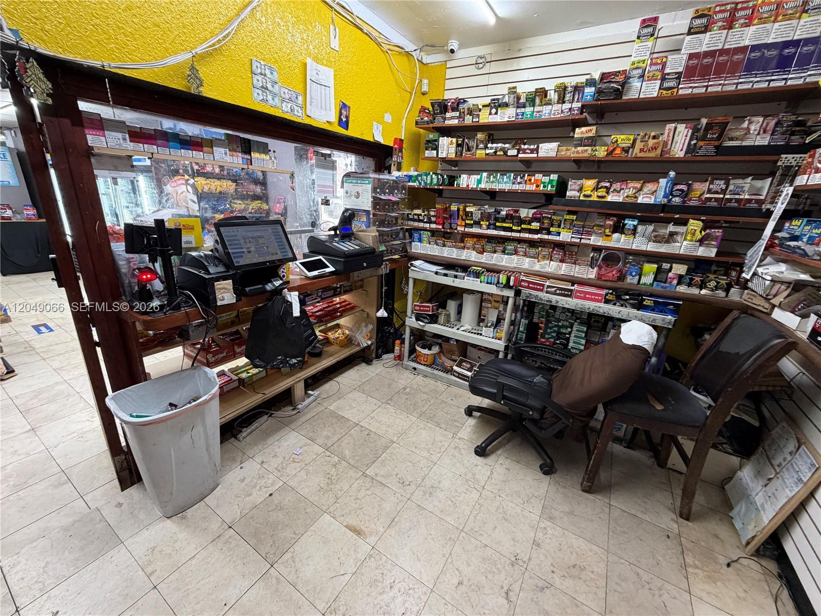 A retail store counter area features shelves stocked with tobacco products and a checkout station — 4980 NW 22nd Ave, Miami FL 33142, MIAMI, FL
