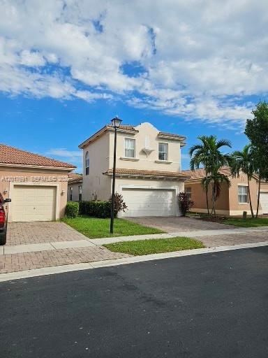A two-story suburban house with a beige stucco exterior and a two-car garage — 2160 NE 37th Rd, Homestead FL 33033, HOMESTEAD, FL