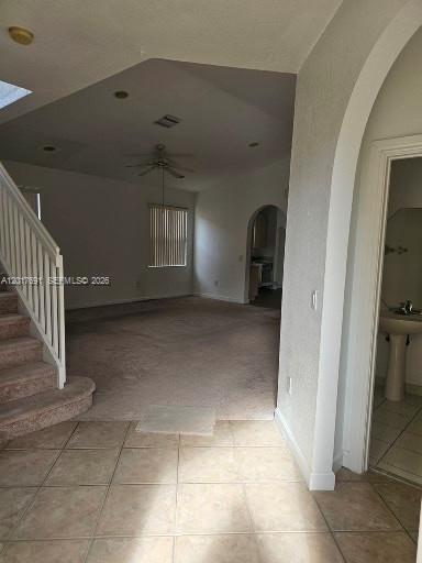 A tiled entryway leads to a carpeted living area with stairs and a small bathroom — 2160 NE 37th Rd, Homestead FL 33033, HOMESTEAD, FL