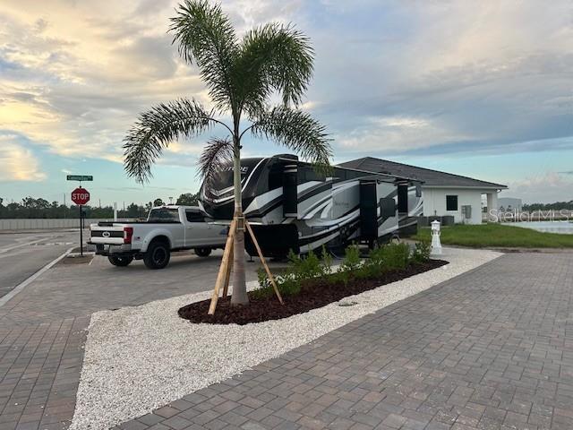 A white pickup truck is parked next to a large RV near a palm tree — 9001 GASPARILLA ROAD UNIT 87, PLACIDA, FL
