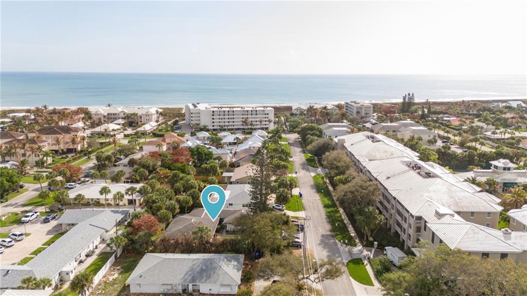An aerial view shows a residential neighborhood near the ocean with a marked house — 919 Turtle Cove Lane, Vero Beach FL 32963, VERO BEACH, FL