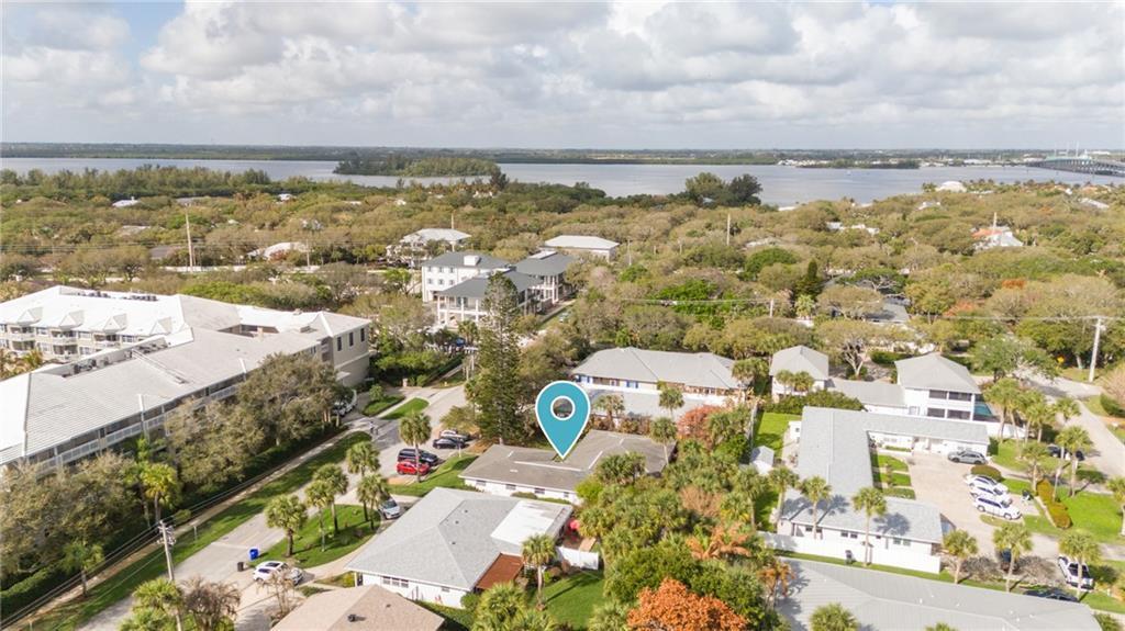 An aerial view shows a residential neighborhood with a blue location pin over a house — 919 Turtle Cove Lane, Vero Beach FL 32963, VERO BEACH, FL