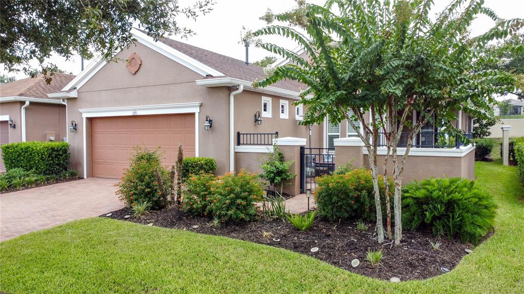 A paved patio features outdoor furniture, a fire pit, and a metal fence enclosure — 255 SILVER MAPLE ROAD, GROVELAND, FL