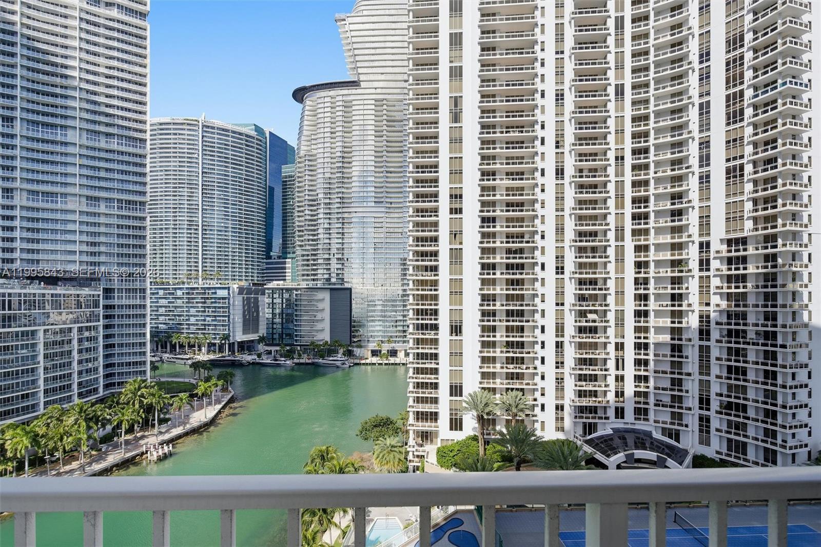 A balcony view overlooks a canal surrounded by multiple high-rise apartment buildings in Miami — 801 Brickell Key Blvd # 1204, Miami FL 33131, MIAMI, FL