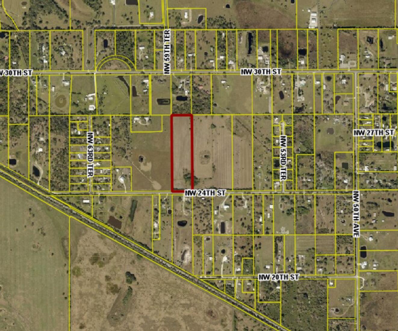 This map shows a rectangular parcel of land outlined in red along a paved road — 5871 NW 24th Street, Okeechobee FL 34972, OKEECHOBEE, FL