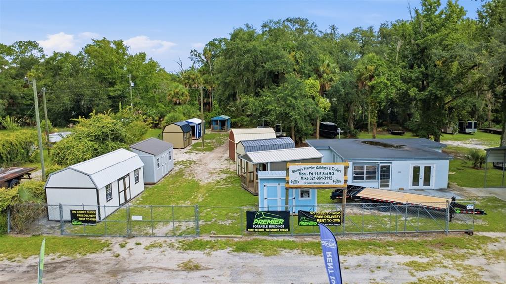 An aerial view shows a sales lot featuring several portable storage buildings and a small office — 2819 W STATE ROAD 44, DELAND, FL
