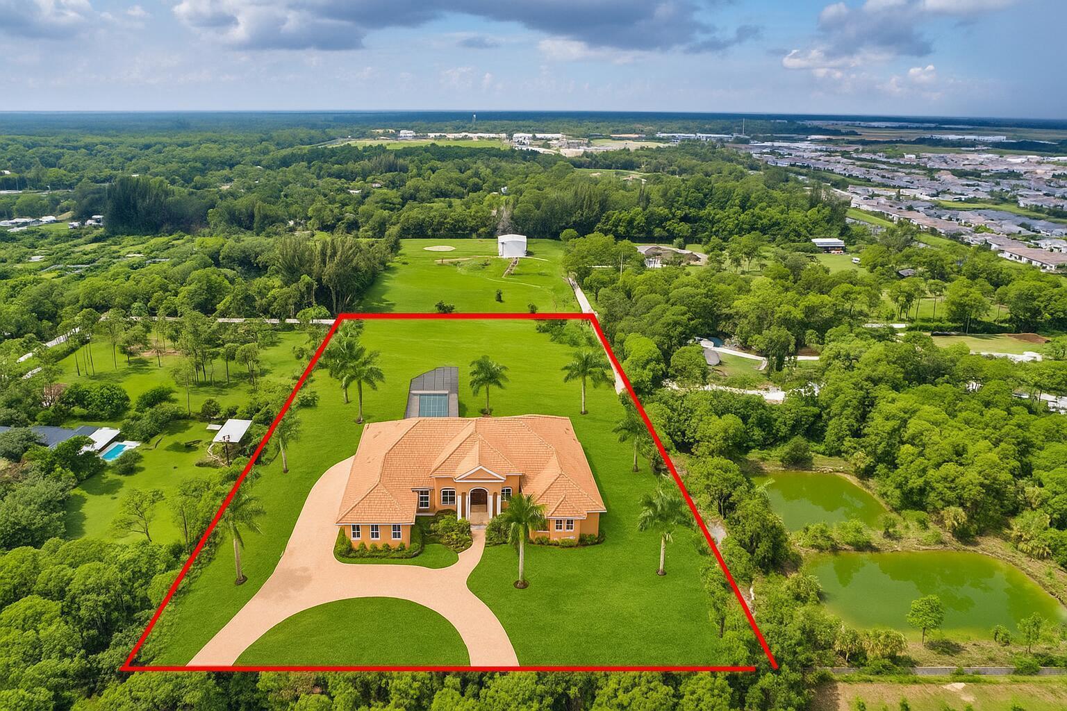 An aerial view shows a single-story orange house with a tiled roof and large lawn — 15532 43rd Road N, FL 33470, FL