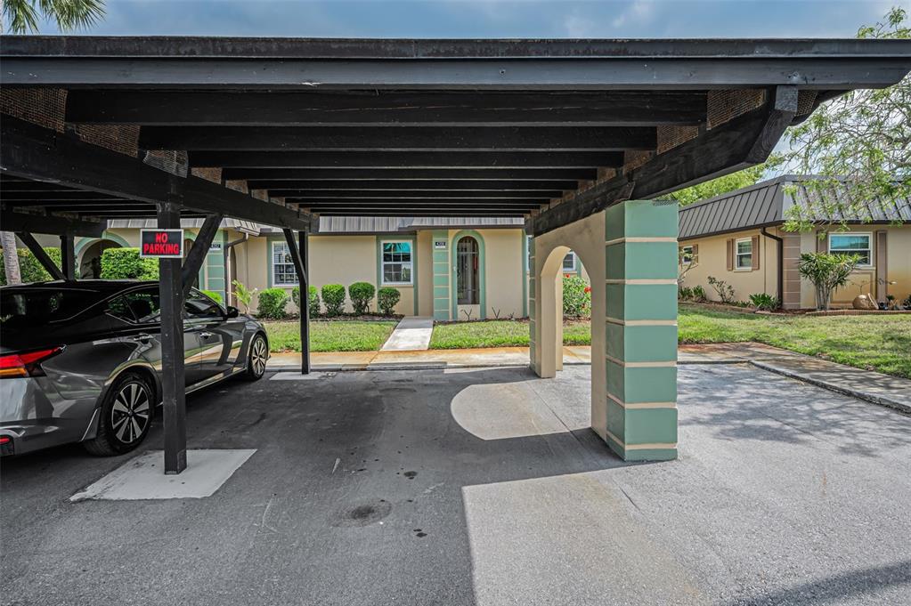 A grassy lawn leads to a canal lined with trees and houses at sunset — 4200 HAMPTON DRIVE, NEW PORT RICHEY, FL