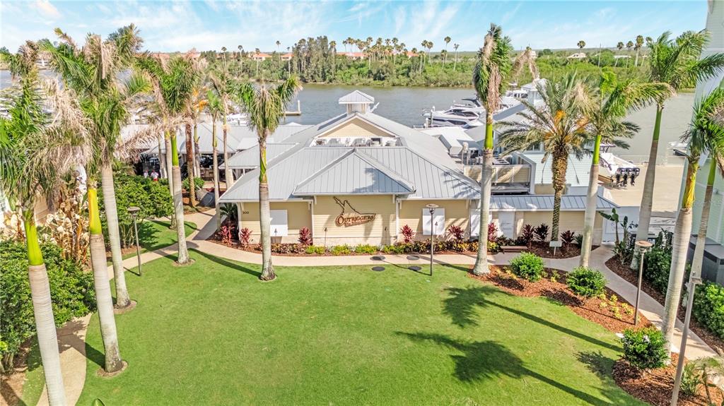 An aerial view shows a waterfront restaurant building with a metal roof and palm trees — 14 OLD FEGER DRIVE, NEW SMYRNA BEACH, FL