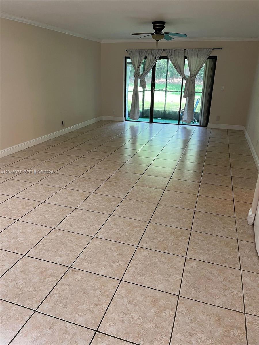 A kitchen features stainless steel appliances, wood cabinets, a dark countertop, and a tiled backsplash — 197 Lakeview Dr # 105, Weston FL 33326, WESTON, FL