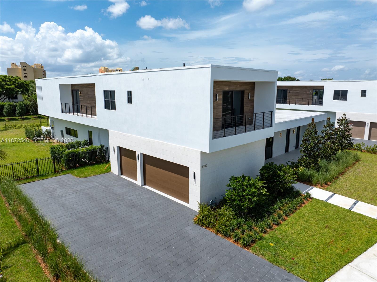 An aerial view shows a modern two-story house with a white exterior, wood accents, and a driveway — 16740 N Botaniko Dr N, Weston FL 33326, WESTON, FL