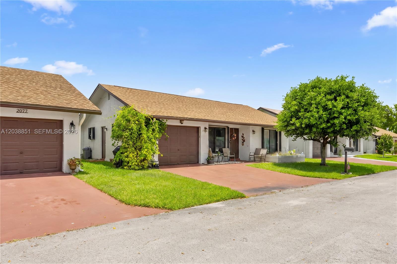 A single-story house with a brown garage door, tan roof, and a front lawn — 2065 SW 17th Dr, Deerfield Beach FL 33442, DEERFIELD BEACH, FL
