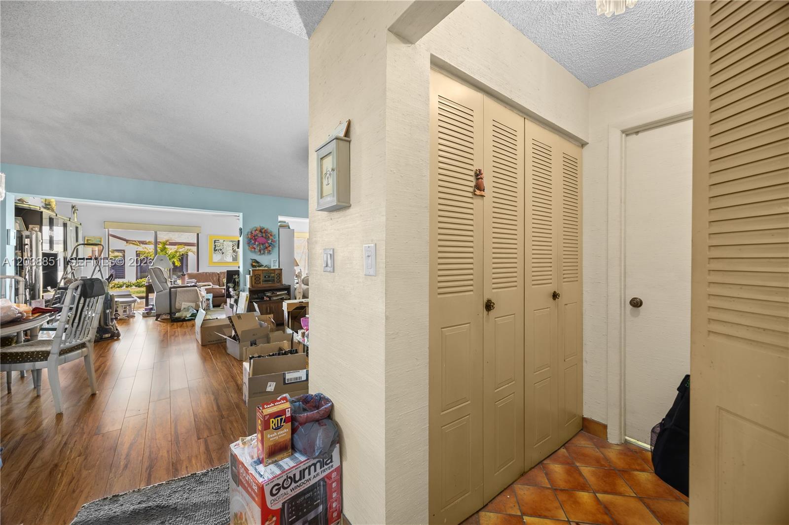 An interior view shows a hallway with tiled floors leading to a living area — 2065 SW 17th Dr, Deerfield Beach FL 33442, DEERFIELD BEACH, FL
