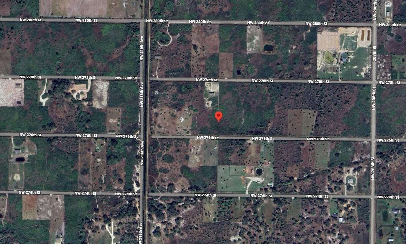 This is a satellite map view of a plot of land marked with a pin — 21377 NW 276th Street, Okeechobee FL 34972, OKEECHOBEE, FL
