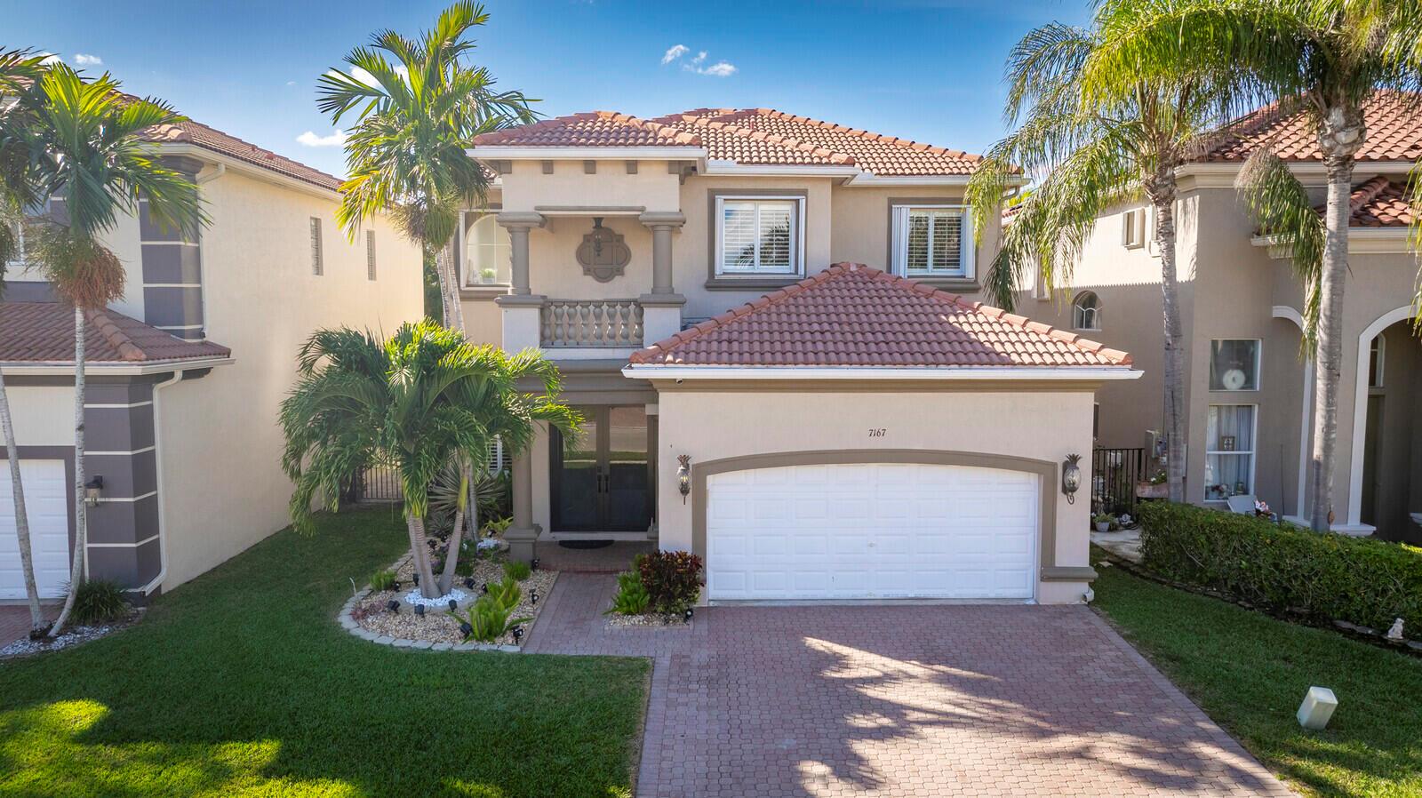 A living and dining area features tile floors, a gray sofa, and a staircase — 7167 Ivy Crossing Lane, Boynton Beach FL 33436, BOYNTON BEACH, FL
