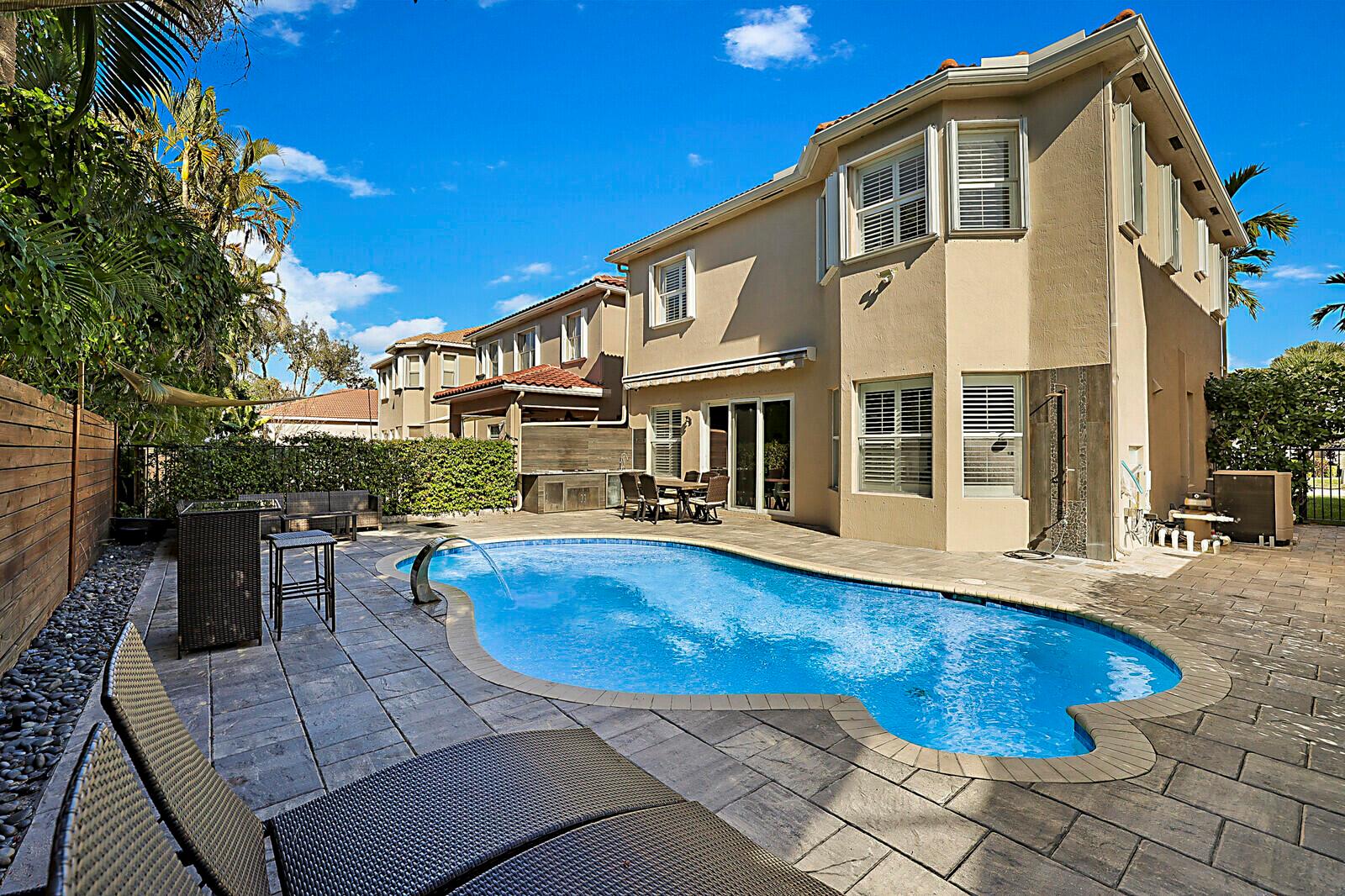 A two-story suburban house with a tiled roof, a white garage, and palm trees — 7167 Ivy Crossing Lane, Boynton Beach FL 33436, BOYNTON BEACH, FL