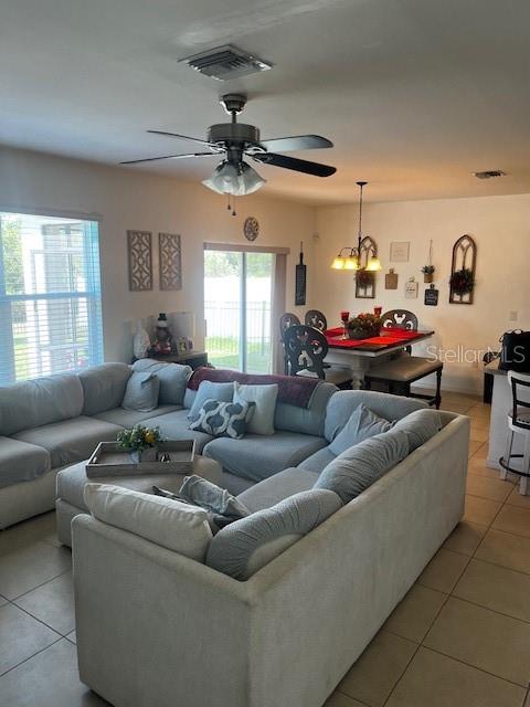 A living room with a sectional sofa, ceiling fan, and an adjacent dining area — 3449 ACAPULCO CIRCLE, CAPE CORAL, FL