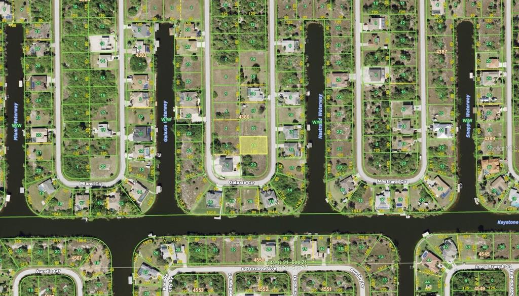 This is a satellite map view of residential lots and waterways in a suburban neighborhood — 9541 GALAXIE CIRCLE, PORT CHARLOTTE, FL