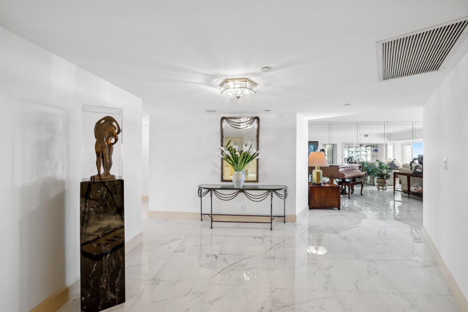 A marble-floored entryway leads through a doorway into a foyer with a PH3 floor mat — 4001 N Ocean Boulevard, Boca Raton FL 33431, BOCA RATON, FL