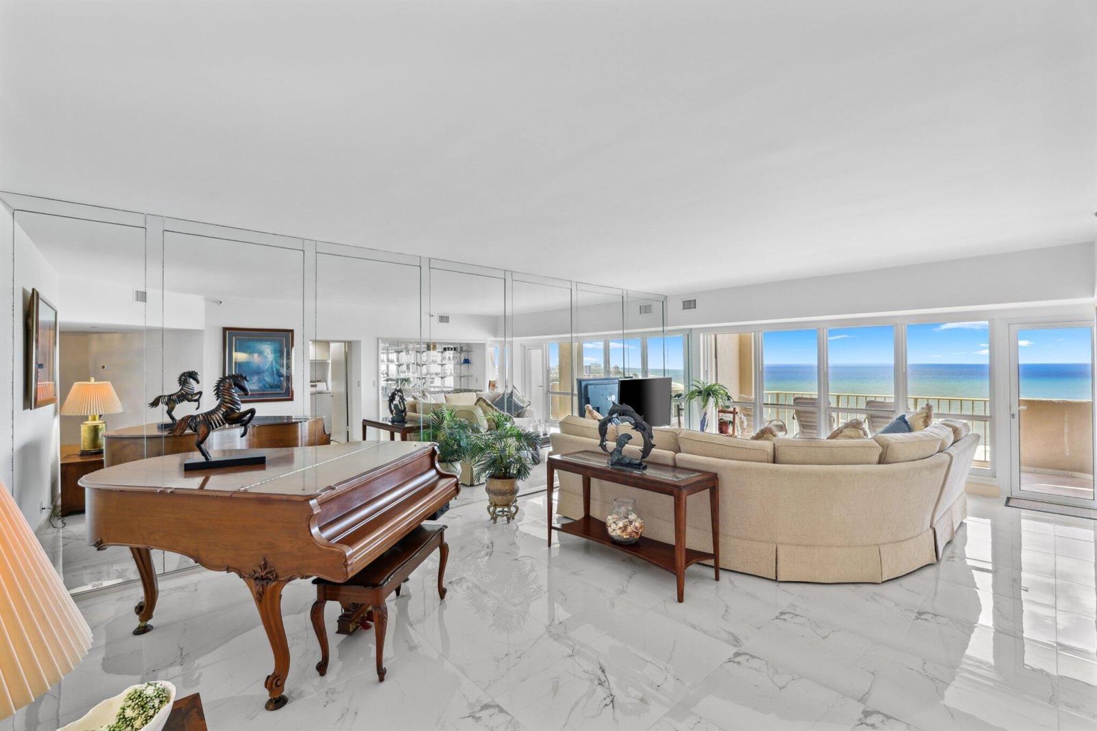 A bright foyer features white marble floors, a sculpture on a pedestal, and a console table — 4001 N Ocean Boulevard, Boca Raton FL 33431, BOCA RATON, FL