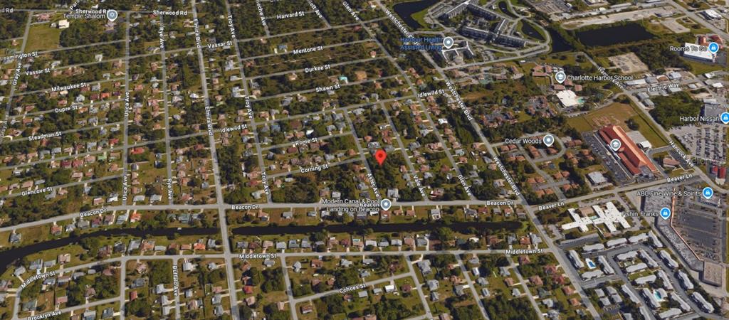 This is an aerial map view of a residential neighborhood with a red location pin — 22453 ASTER AVENUE, PUNTA GORDA, FL