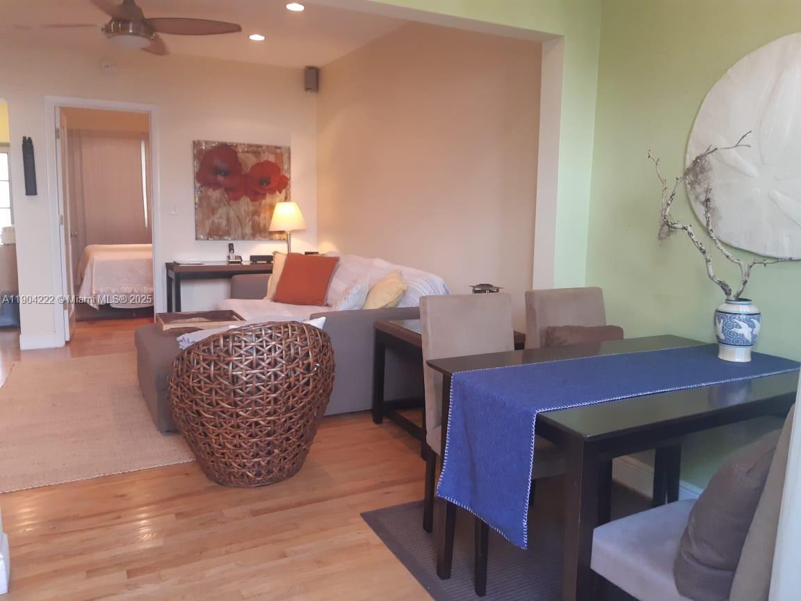 A living and dining area features hardwood floors, a sofa, and a dining table — 744 Lenox Ave # 3, Miami Beach FL 33139, MIAMI BEACH, FL