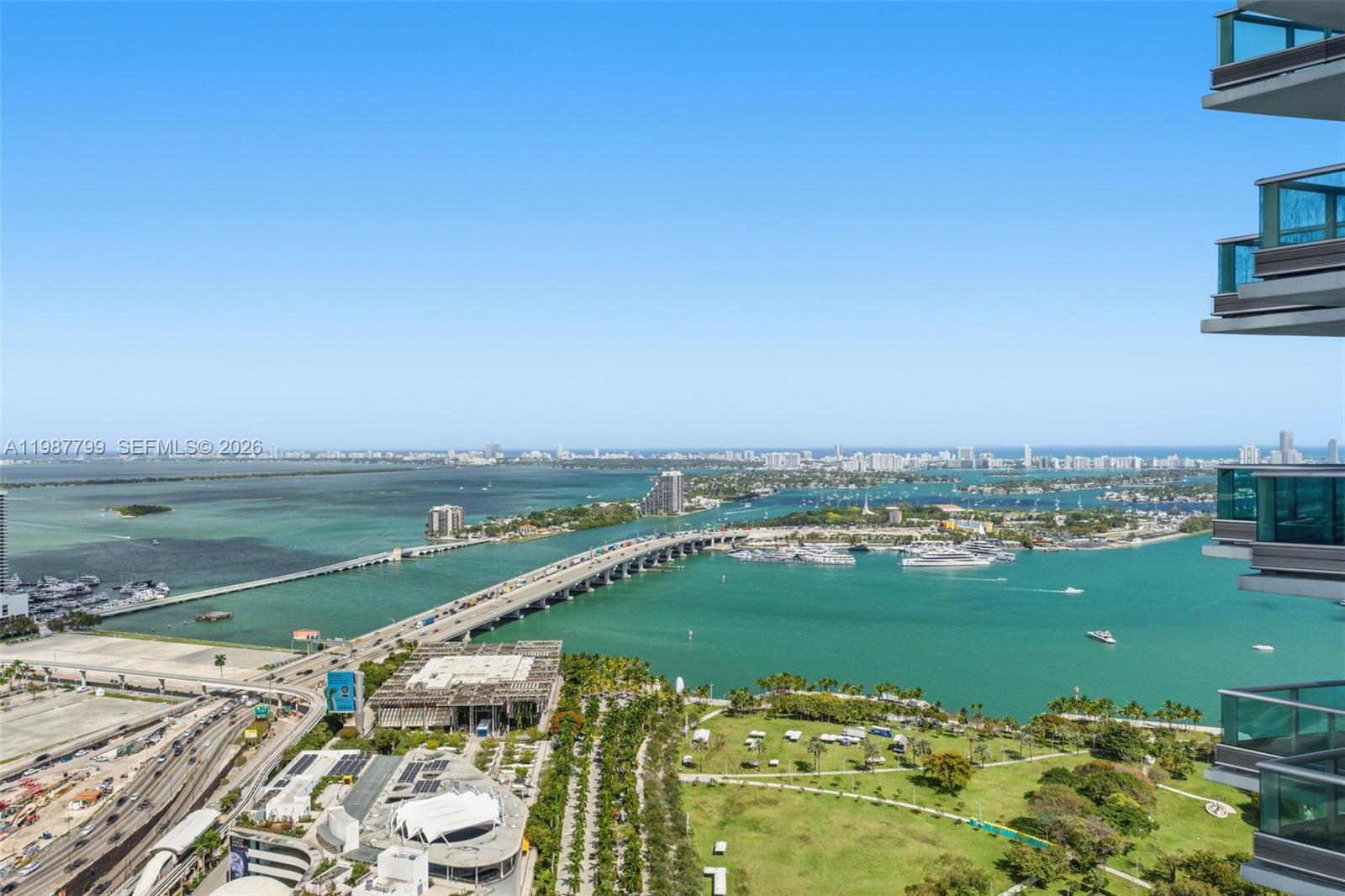 An elevated view shows a bridge crossing a bay toward a distant city skyline — 900 Biscayne Blvd # 4308, Miami FL 33132, MIAMI, FL