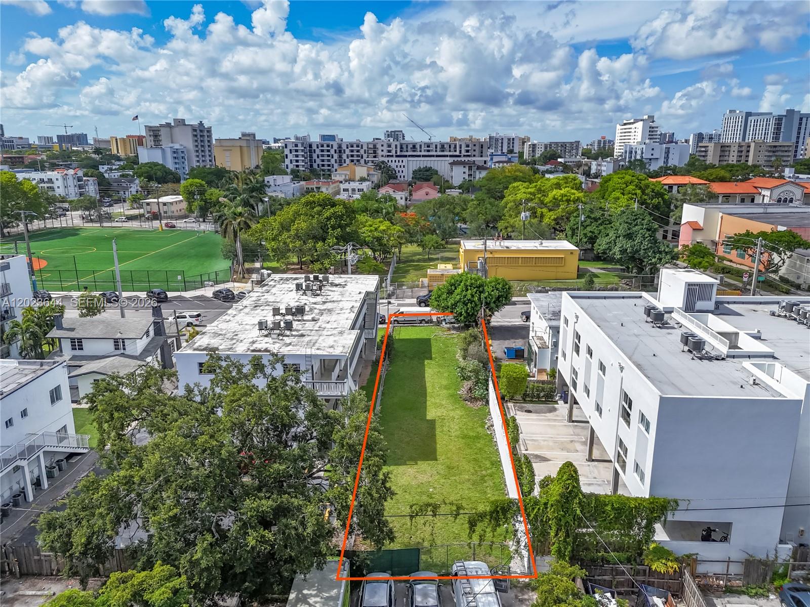 An aerial view shows a rectangular vacant lot bordered by residential buildings and trees — 718 SW 4th St, Miami FL 33130, MIAMI, FL