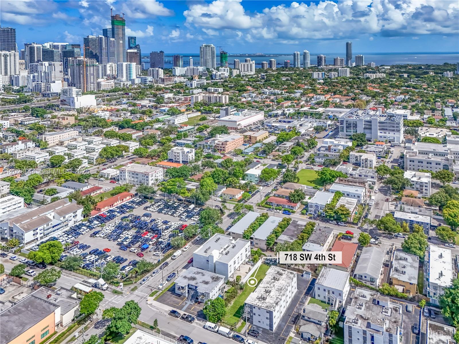An aerial view shows a multi-story apartment building in a dense urban neighborhood — 718 SW 4th St, Miami FL 33130, MIAMI, FL