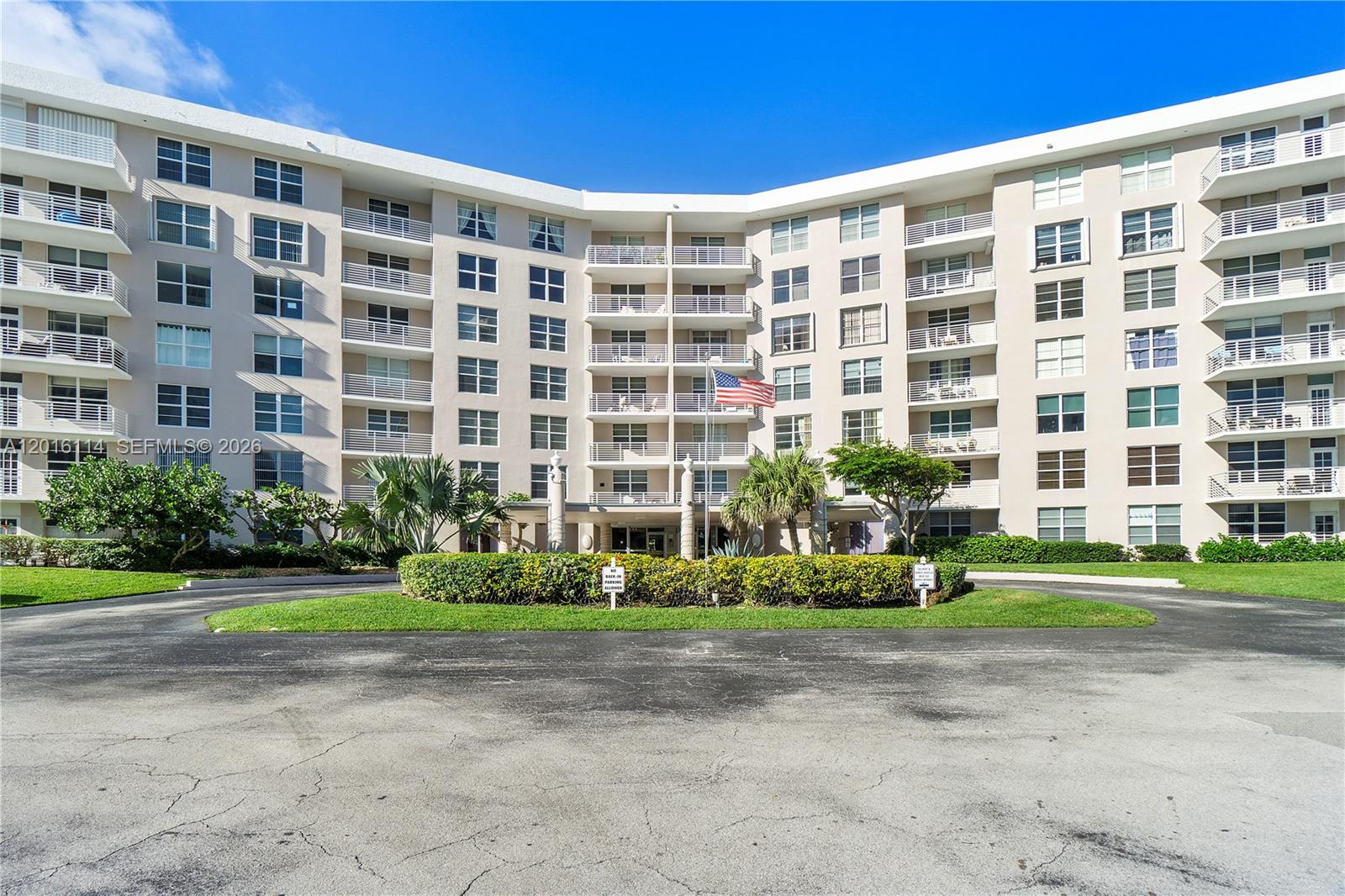 A multi-story apartment building features a circular driveway and a central entrance with landscaping — 2851 S Ocean Blvd # 7U, Boca Raton FL 33432, BOCA RATON, FL