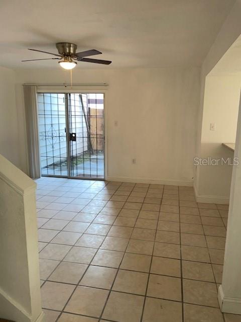 A room with light-colored tile flooring, a ceiling fan, and sliding glass doors to a patio — 3994 CRAYRICH CIRCLE UNIT C4, ORLANDO, FL