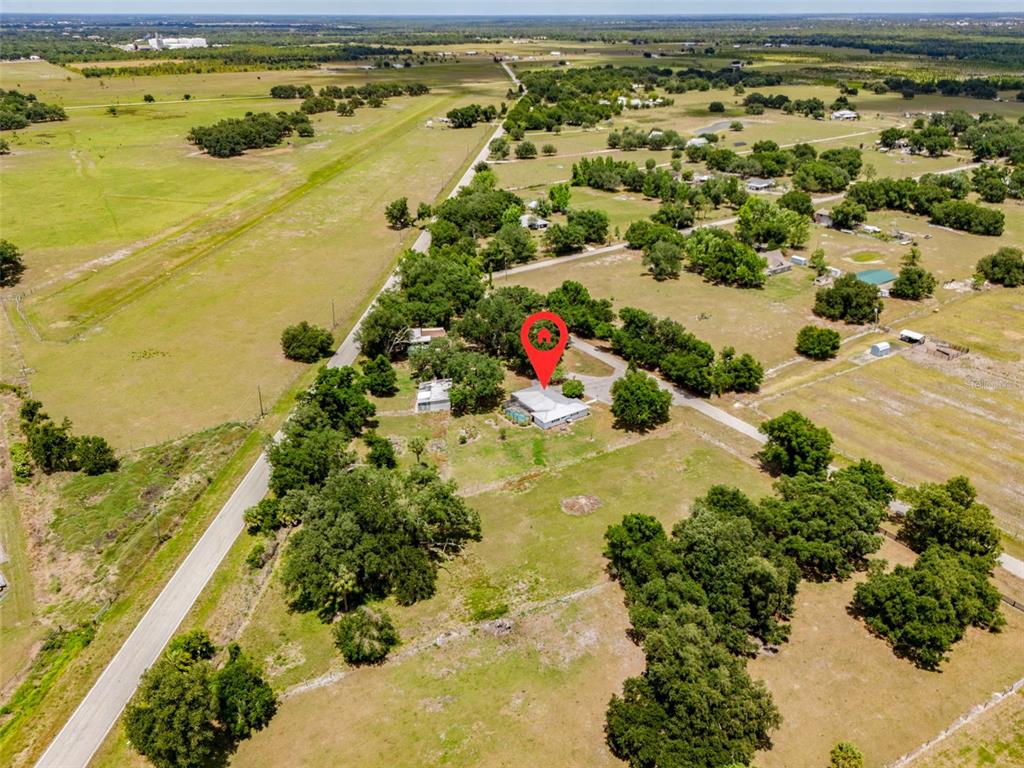 An aerial view shows a house with a red location pin on rural land — 2087 SW GARNER AVENUE, ARCADIA, FL