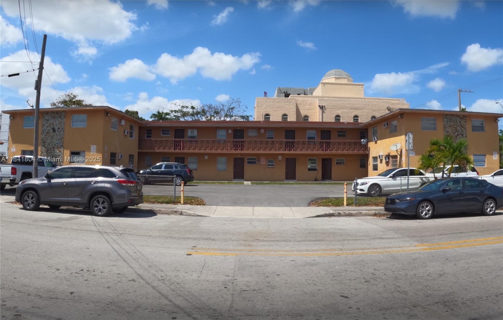 A two-story apartment building with a central courtyard and parking lot in front — 1701 SW 3rd St, Miami FL 33135, MIAMI, FL