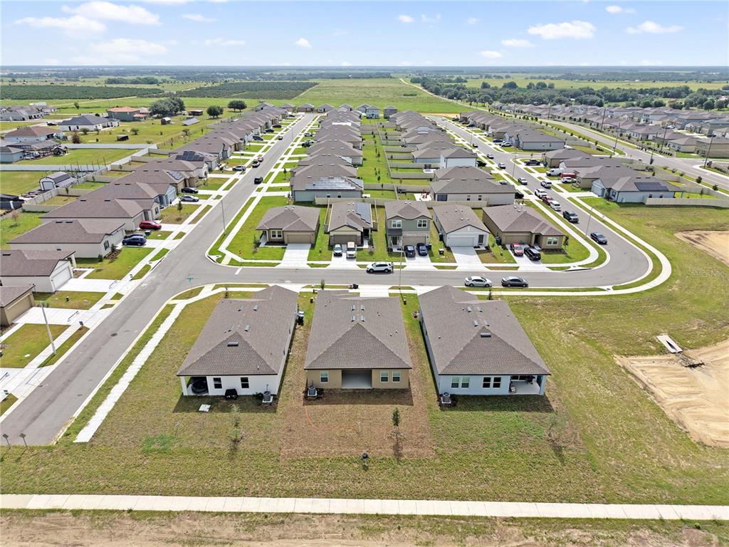 An aerial view shows a suburban neighborhood with rows of single-family homes and paved streets — 3008 DAFFODIL DRIVE, LAKE HAMILTON, FL