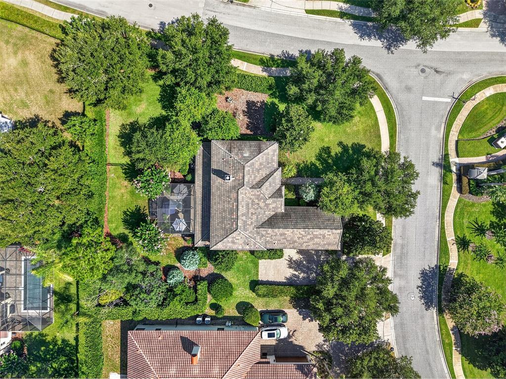 A curved sidewalk borders a grassy lawn in front of a two-story residential building — 3000 ISOLA BELLA BOULEVARD, MOUNT DORA, FL