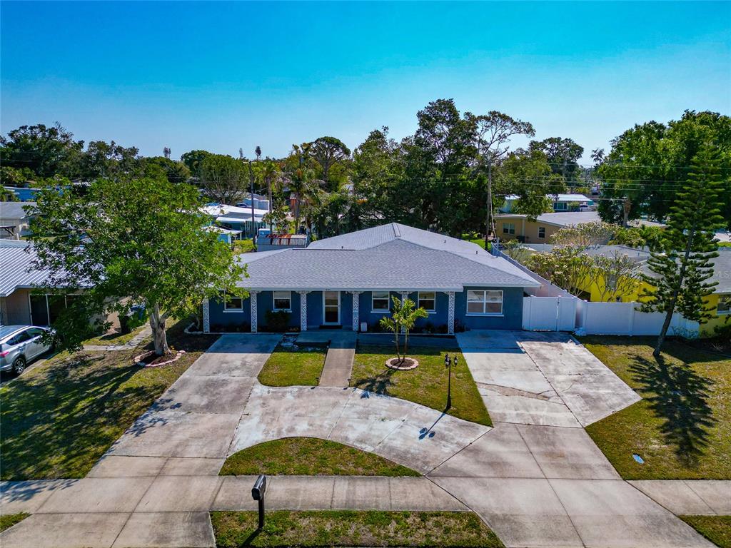 An aerial view of a single-story house with a gray roof and a concrete driveway — 6511 GEORGIA AVENUE, BRADENTON, FL