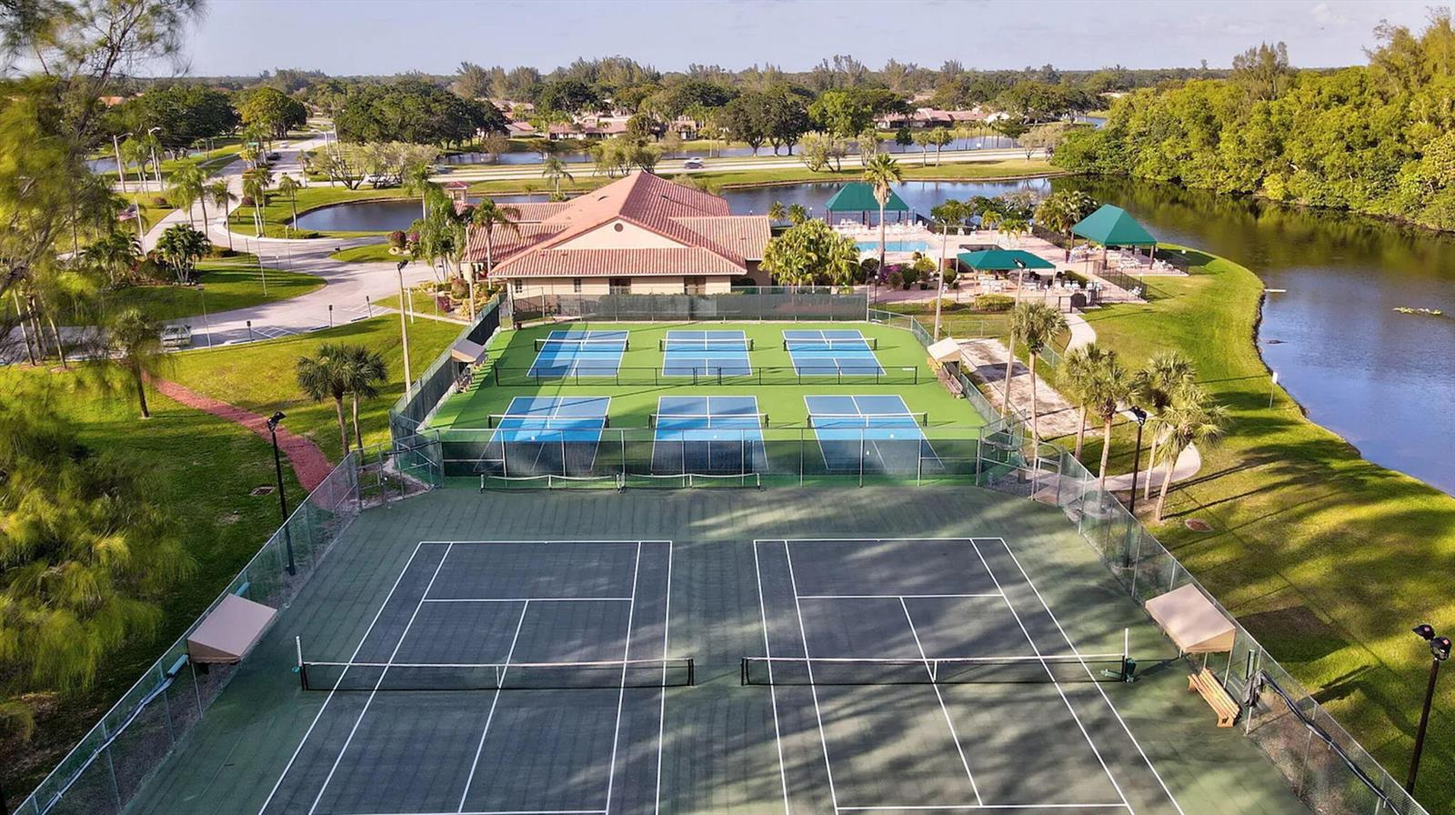 An aerial view of two dark tennis courts in front of six blue pickleball courts — 5881 Parkwalk Drive, Boynton Beach FL 33472, BOYNTON BEACH, FL