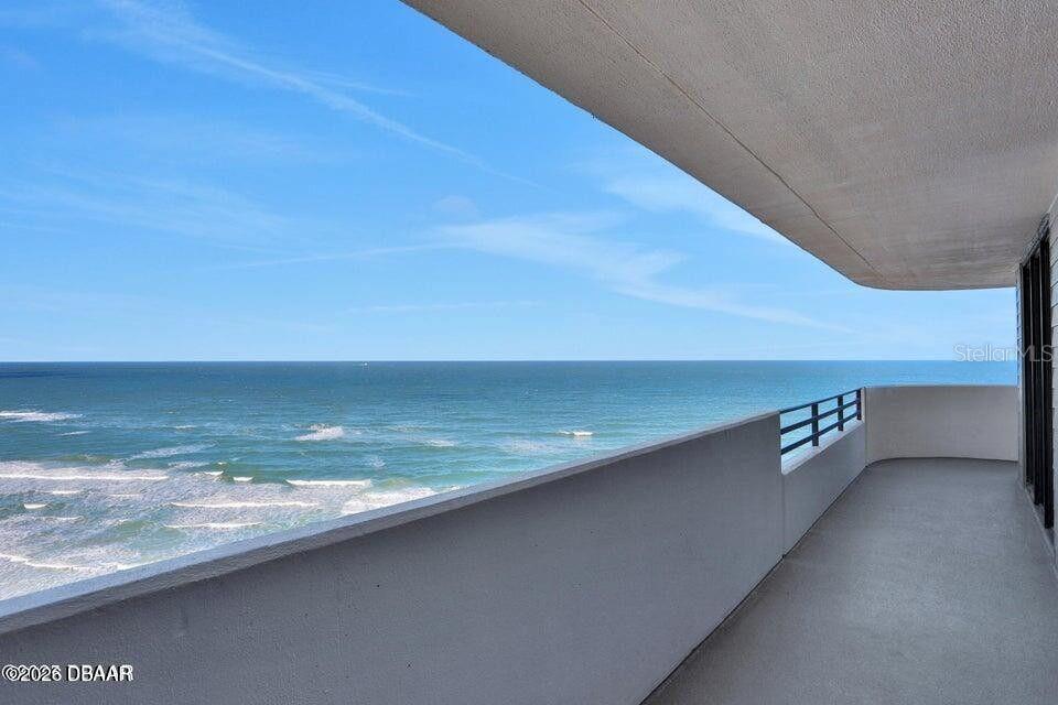 A balcony overlooks the ocean under a clear blue sky — 1420 N ATLANTIC AVENUE UNIT 901, DAYTONA BEACH, FL