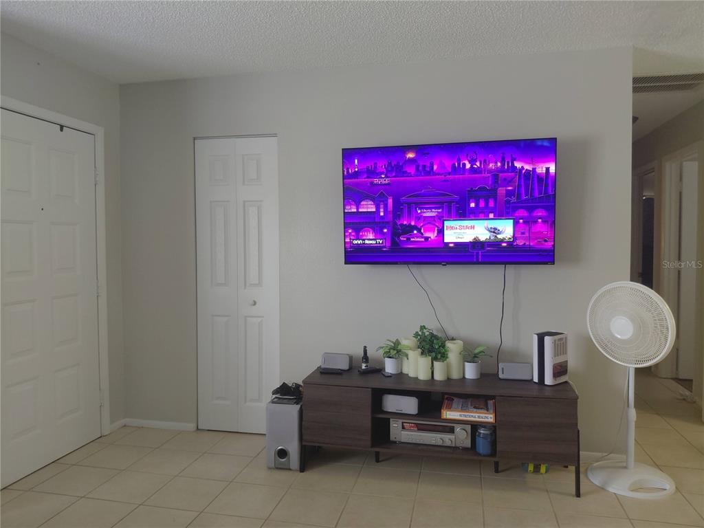 A living room features a wall-mounted television above a dark wood media console — 351 TERRAPIN ROAD, VENICE, FL