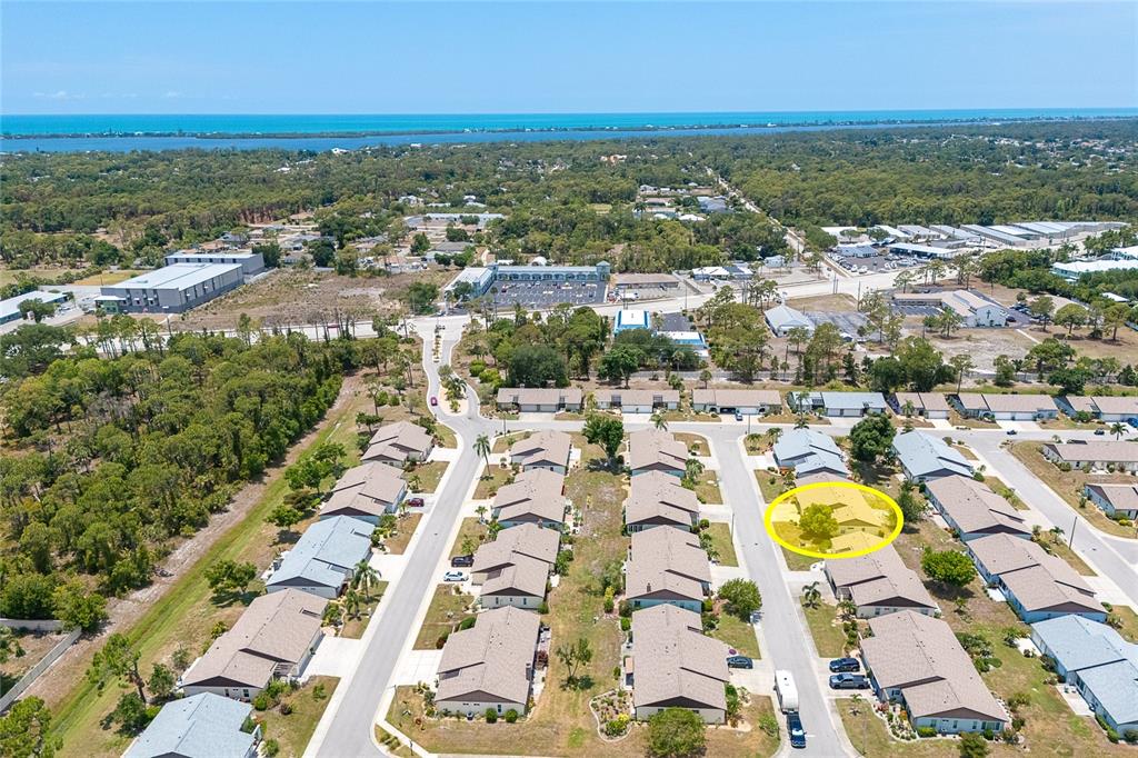 An aerial view shows a residential neighborhood with a yellow circle highlighting a specific house — 206 ASPEN STREET, ENGLEWOOD, FL