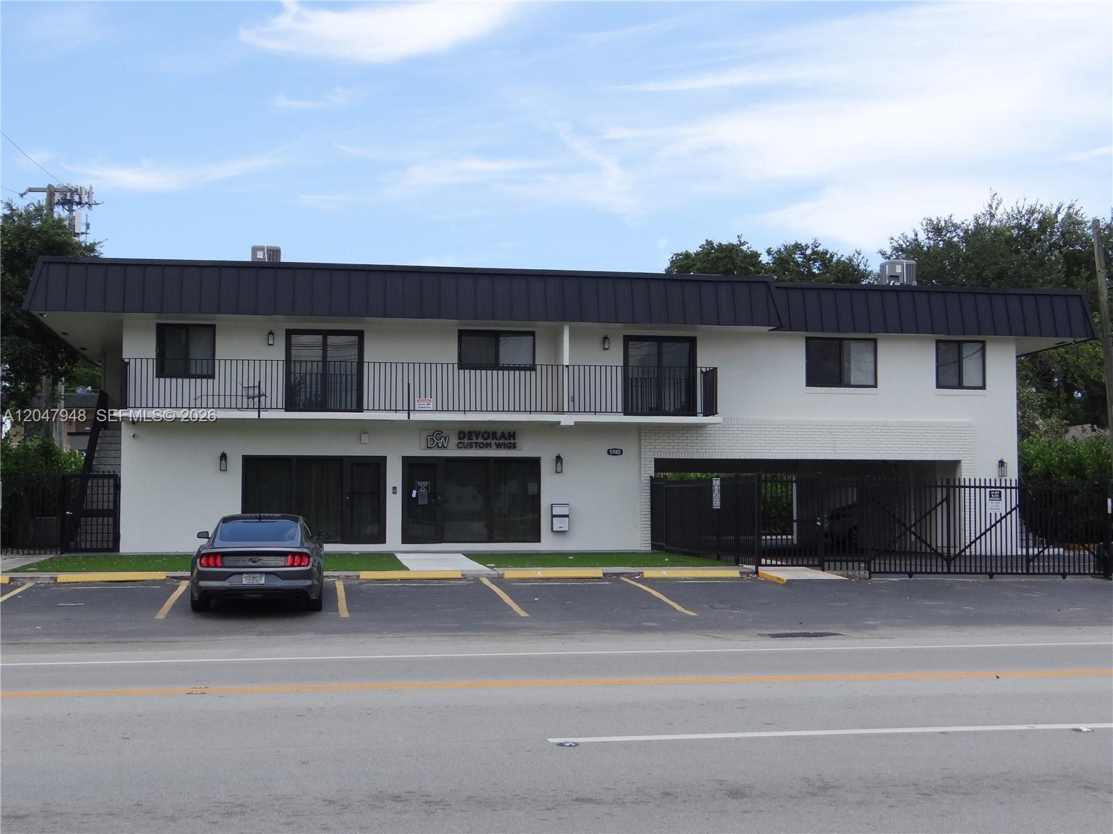 A two-story commercial building with a parking lot and a black metal roof — 5980 SW 40th Ave # D, Dania Beach FL 33312, DANIA BEACH, FL