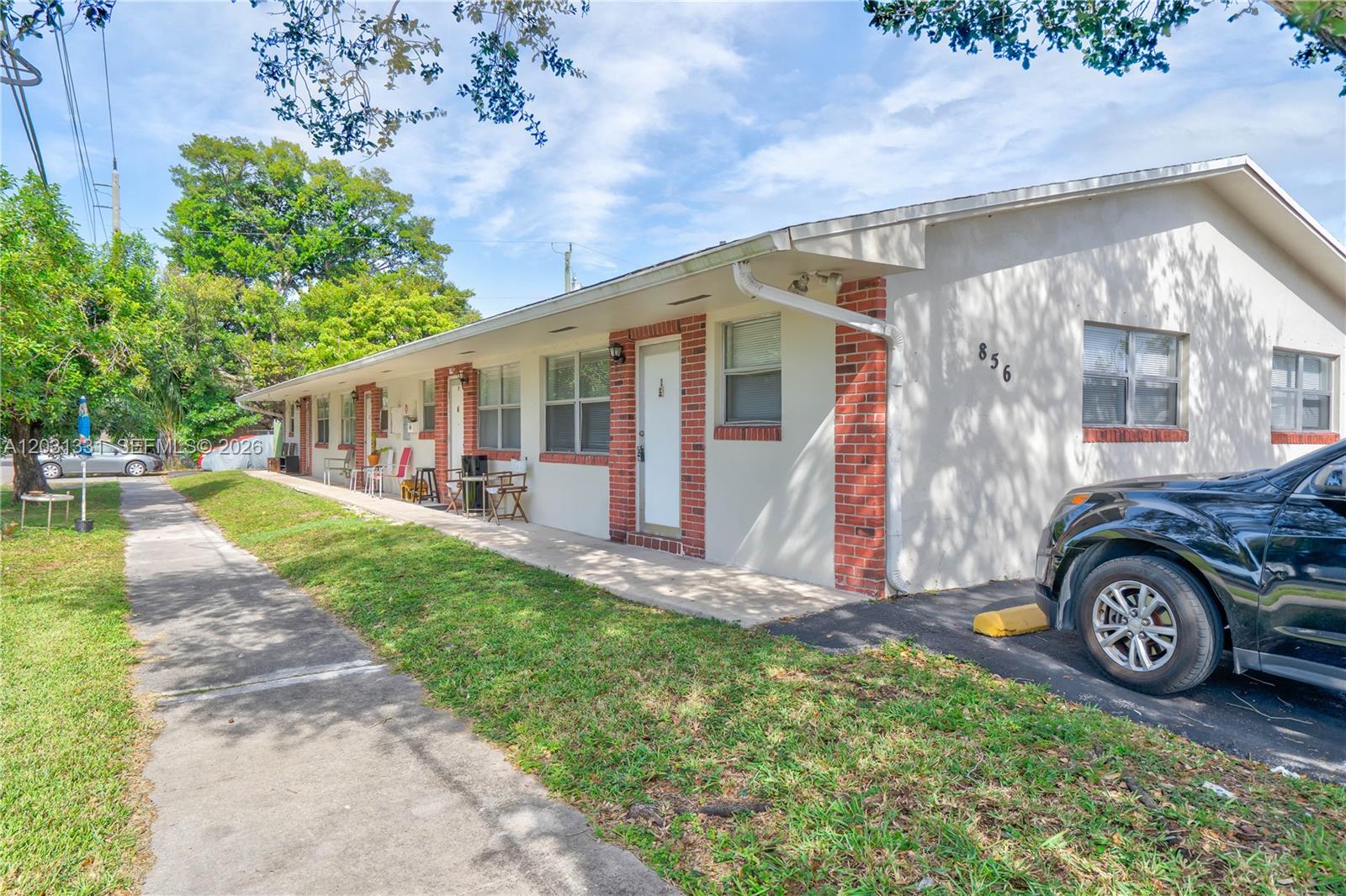 A single-story apartment building with a brick-accented exterior and a paved parking area — 856 SW 10th St # 1, Hallandale Beach FL 33009, HALLANDALE BEACH, FL