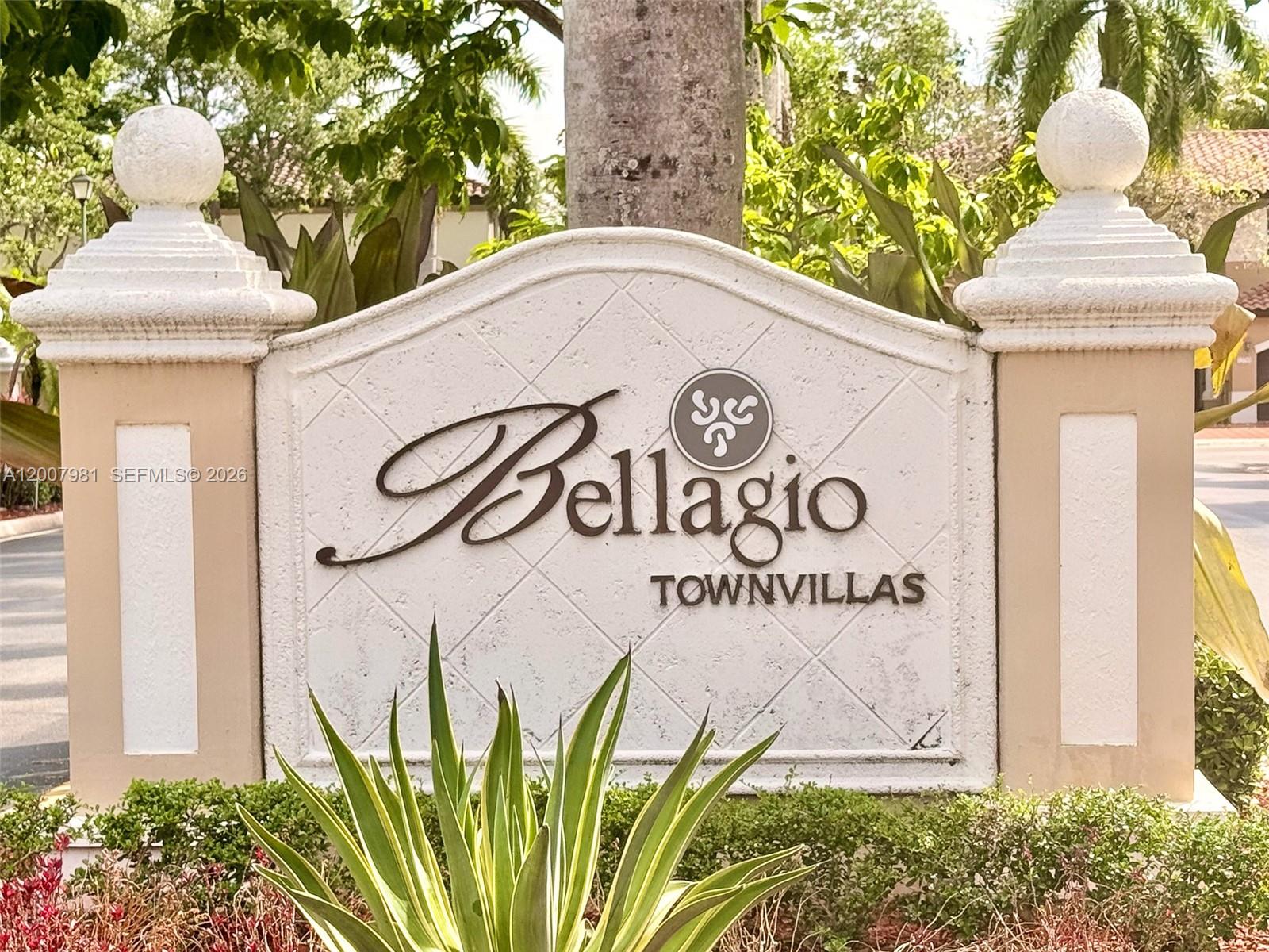 A stone monument sign for Bellagio Townvillas stands outdoors surrounded by landscaping — 12740 SW 50th St, Miramar FL 33027, MIRAMAR, FL