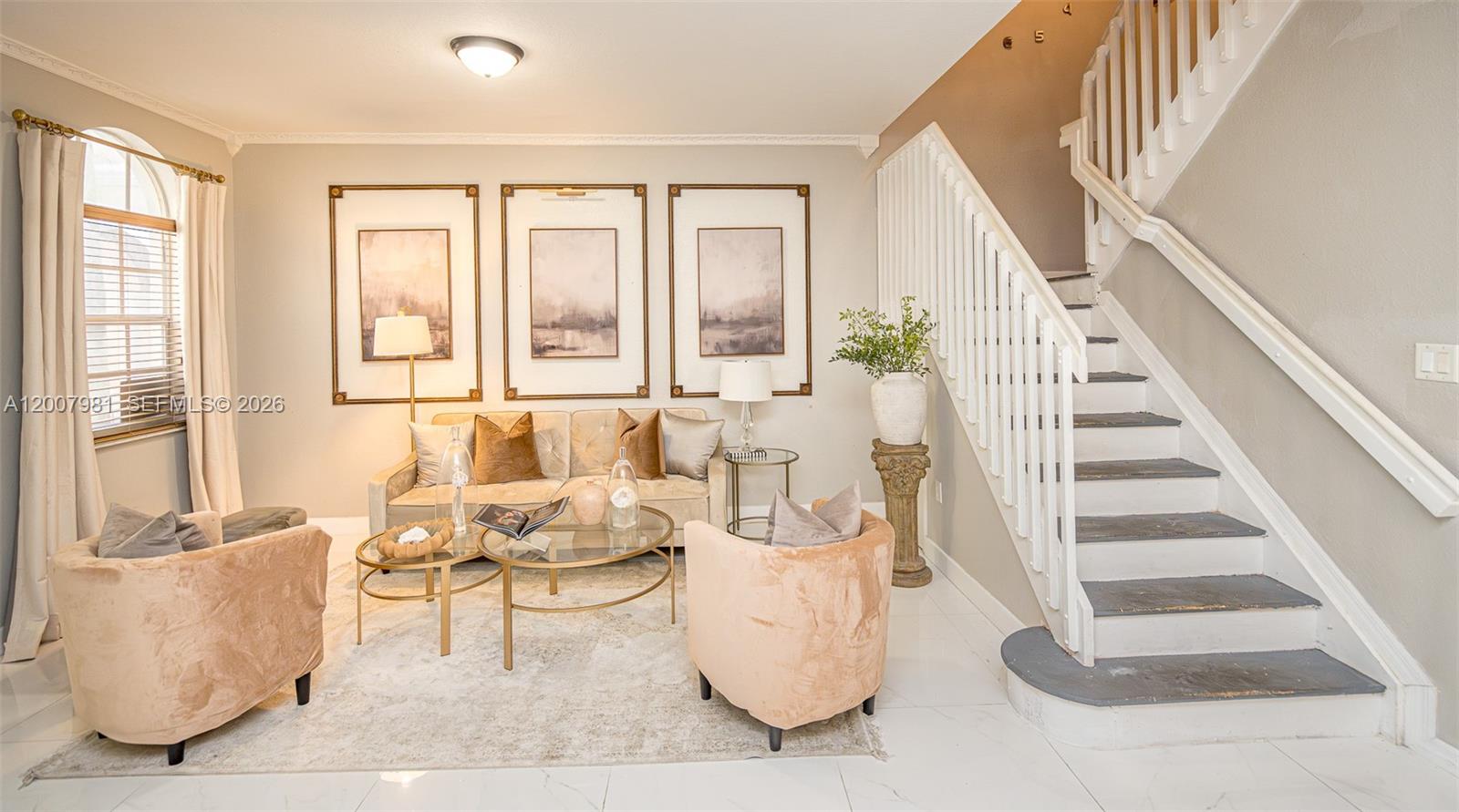 A living room features a staircase, a sofa, two armchairs, and three framed wall pictures — 12740 SW 50th St, Miramar FL 33027, MIRAMAR, FL