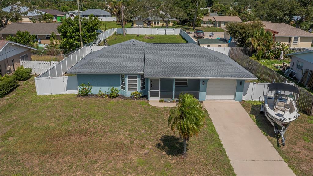 An aerial view of a single-story blue house with a gray roof and a boat — 1510 NANTUCKET ROAD, VENICE, FL